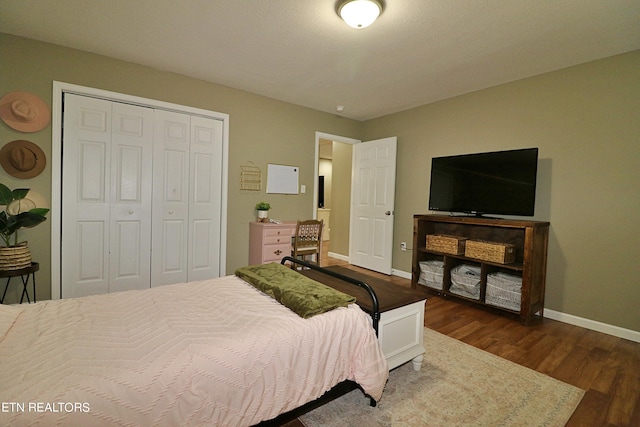 bedroom featuring a closet and dark hardwood / wood-style flooring