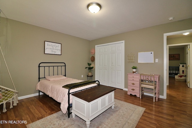 bedroom with a closet and dark hardwood / wood-style flooring