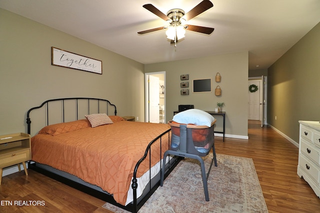 bedroom with ceiling fan, hardwood / wood-style flooring, and ensuite bathroom