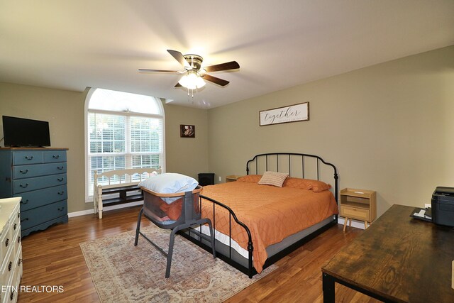 bedroom with ceiling fan and dark wood-type flooring