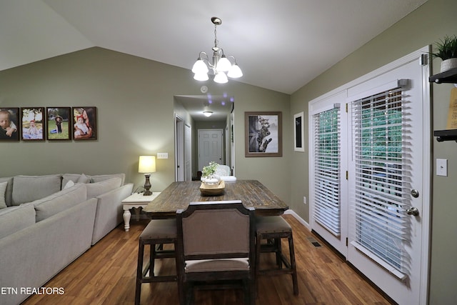 dining room featuring an inviting chandelier, lofted ceiling, and dark hardwood / wood-style floors