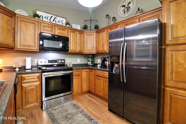 kitchen with stainless steel appliances and light hardwood / wood-style floors