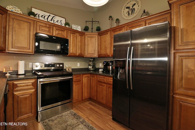 kitchen featuring light wood-type flooring and appliances with stainless steel finishes