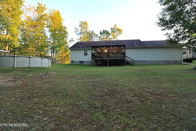 back of house with a lawn