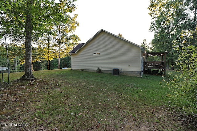 view of property exterior with a deck, central air condition unit, and a yard