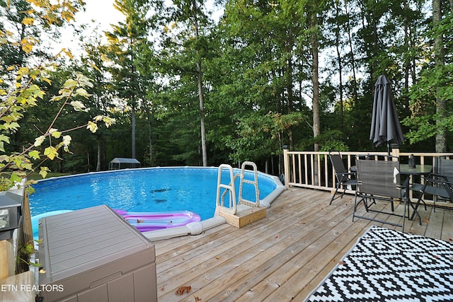 view of swimming pool with a wooden deck