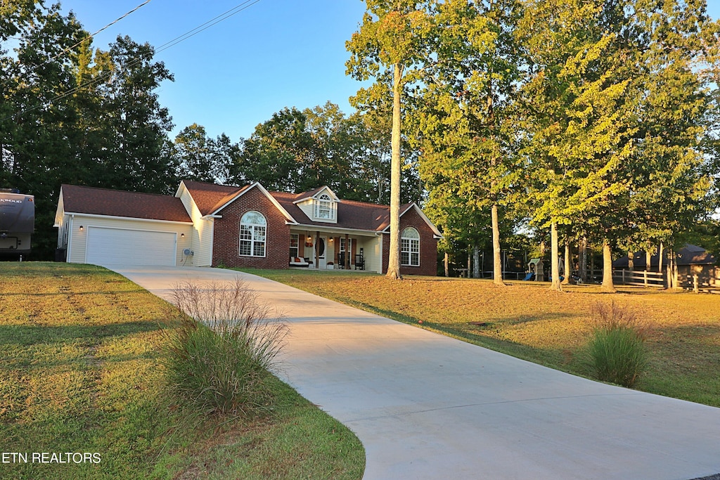 view of front of house with a front yard and a garage