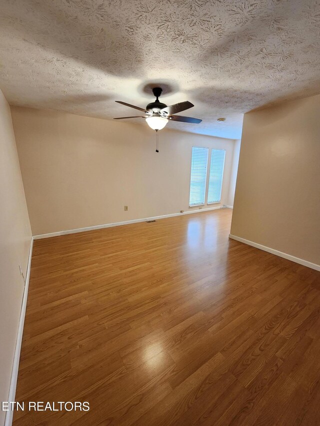 5725 Academy Dr, Morristown, TN 37814 - unfurnished room featuring a textured ceiling, ceiling fan, and hardwood / wood-style flooring