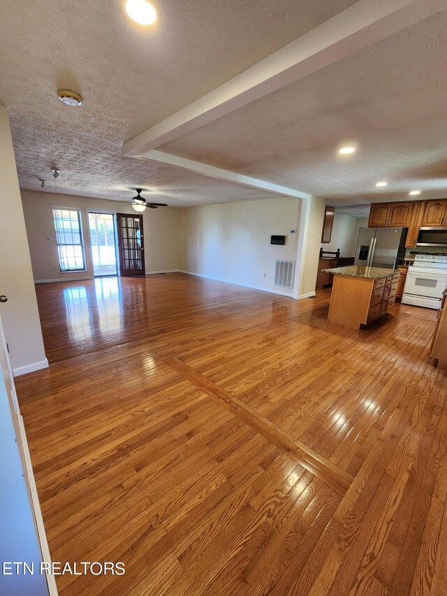 5725 Academy Dr, Morristown, TN 37814 - unfurnished living room with light wood-type flooring and a textured ceiling