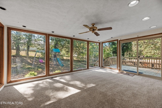 unfurnished sunroom with ceiling fan and plenty of natural light