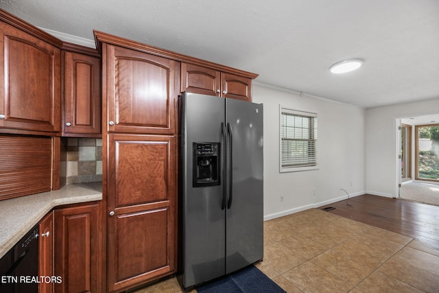 kitchen with light wood-type flooring, tasteful backsplash, stainless steel fridge with ice dispenser, and crown molding