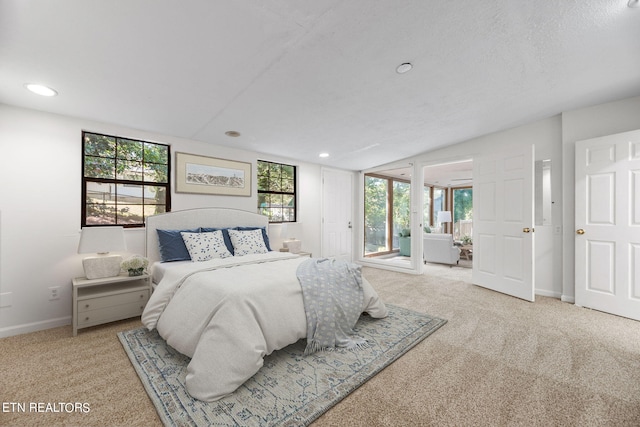 carpeted bedroom with multiple windows and a textured ceiling