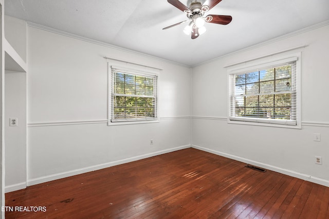 empty room with a wealth of natural light, ceiling fan, crown molding, and dark hardwood / wood-style flooring