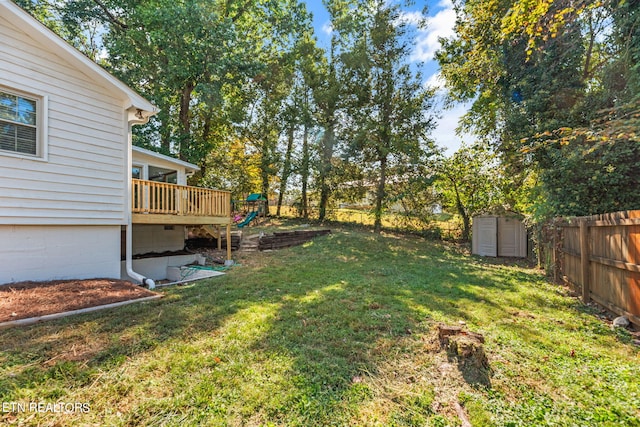 view of yard featuring a deck and a storage unit