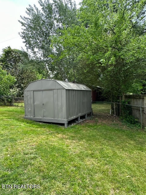 view of outdoor structure featuring a lawn