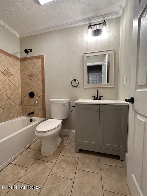 full bathroom with crown molding, vanity, toilet, and tiled shower / bath