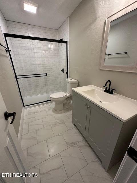 617 Ardmore Cir, Maryville, TN 37804 - bathroom with a stall shower, toilet, vanity, a textured ceiling, and marble finish floor