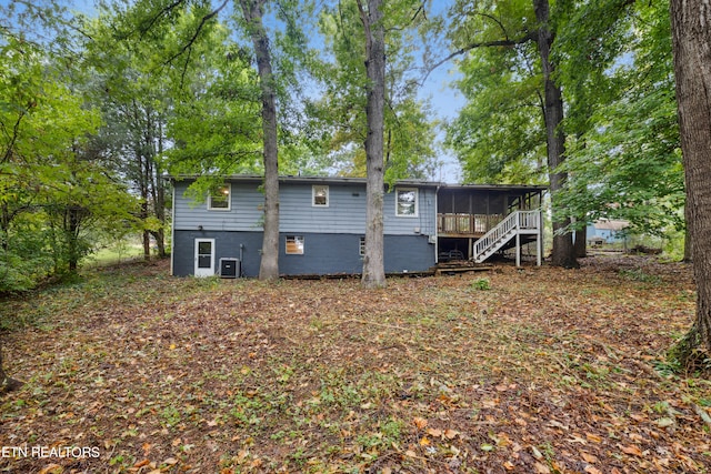 back of house featuring a sunroom and central AC