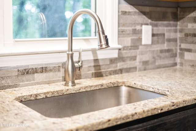 details with light stone countertops and sink