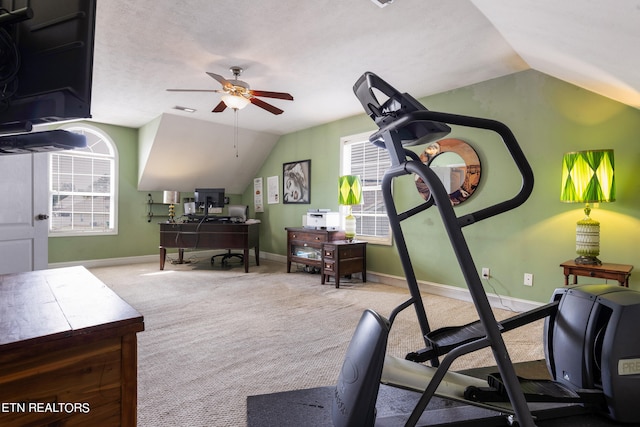 workout room featuring carpet, ceiling fan, vaulted ceiling, and a textured ceiling