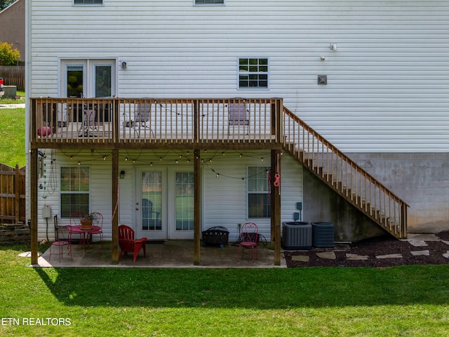 back of property featuring a lawn, a patio, and central AC