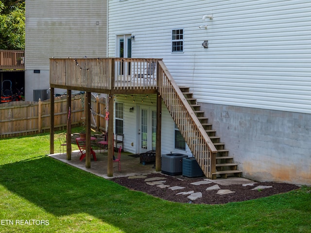 deck with a lawn, a patio, and central AC