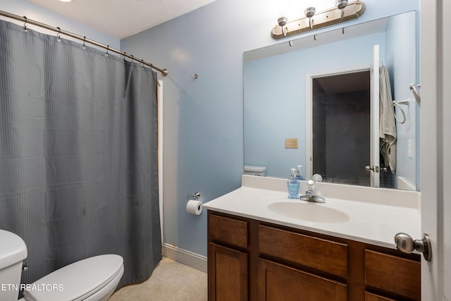 bathroom with vanity, toilet, and tile patterned floors