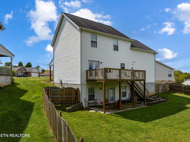 rear view of house featuring a patio, a deck, and a yard