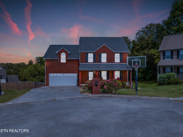 view of property featuring a yard and a garage