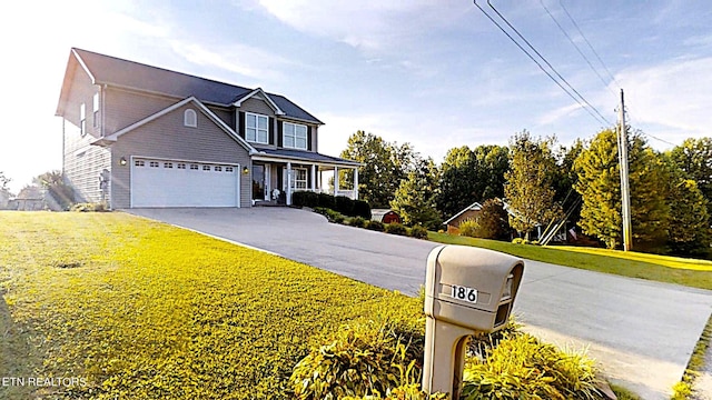 view of front of house with a garage and a front lawn