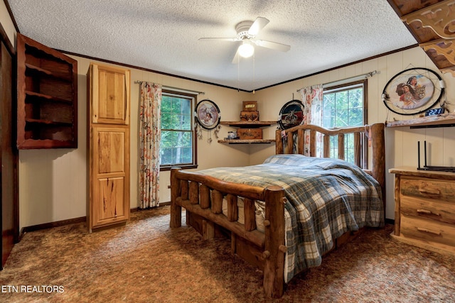 bedroom featuring ceiling fan, a textured ceiling, and multiple windows