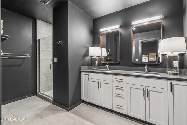 bathroom featuring tile patterned flooring, walk in shower, and vanity