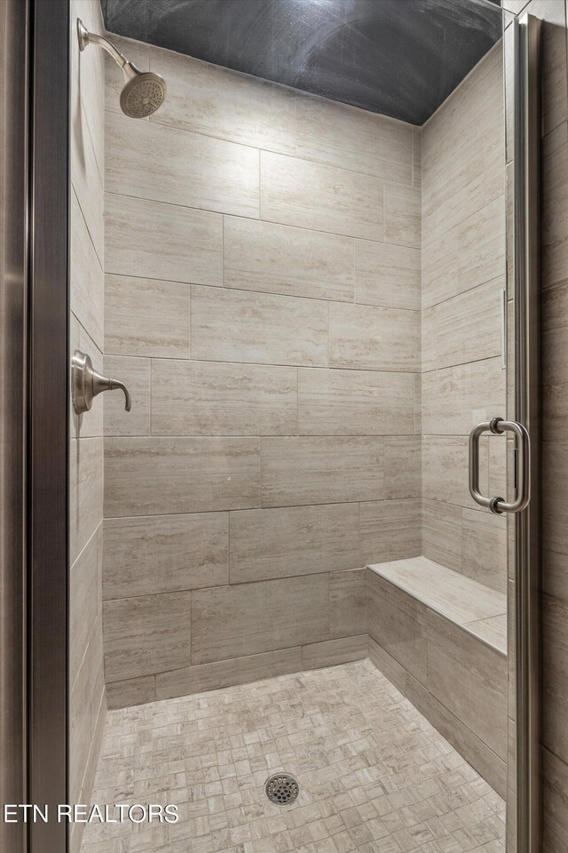 bathroom with a shower with door