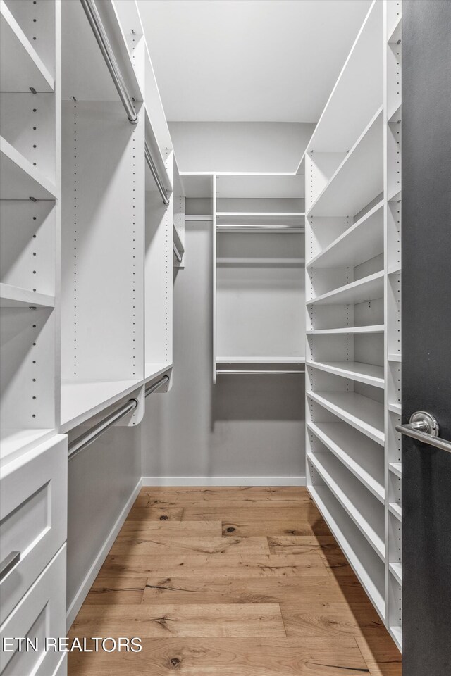 walk in closet featuring light hardwood / wood-style floors