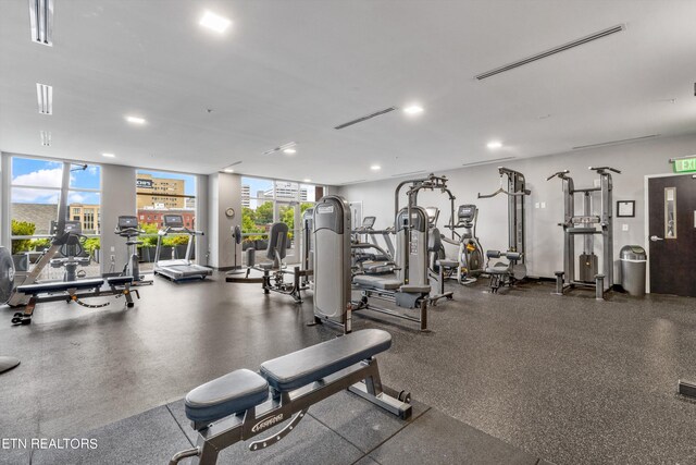 gym with a wall of windows