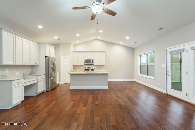 kitchen featuring white cabinets, appliances with stainless steel finishes, and dark wood-type flooring