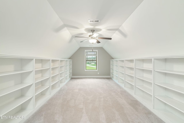 additional living space featuring light colored carpet, vaulted ceiling, and ceiling fan