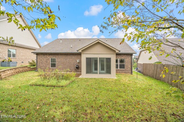 rear view of house with a yard