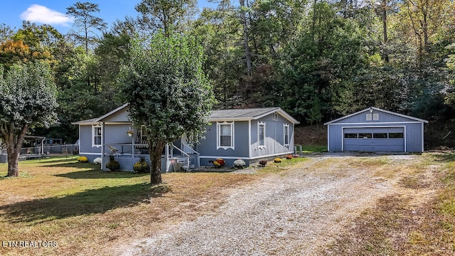 view of front of house featuring a front yard, an outdoor structure, and a garage