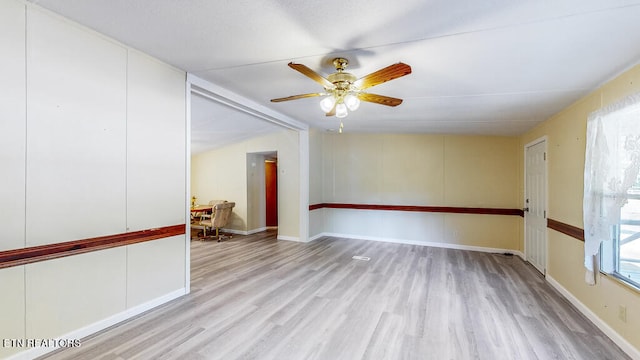 empty room with light wood-type flooring and ceiling fan