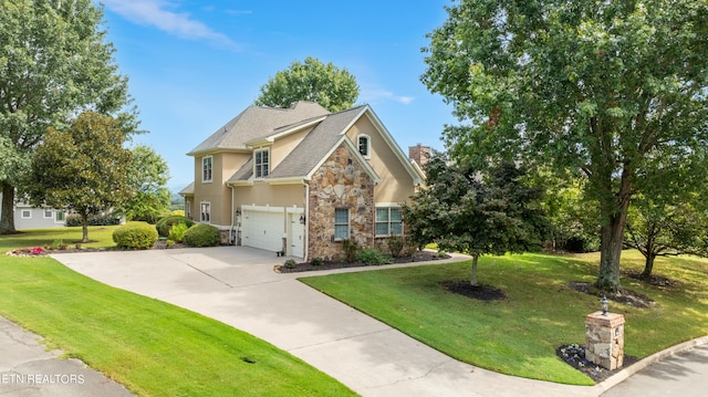 view of front facade with a garage and a front lawn