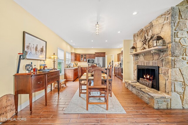 interior space with light hardwood / wood-style floors, a stone fireplace, and sink