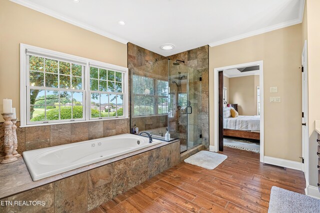 bathroom featuring ornamental molding, wood-type flooring, and independent shower and bath