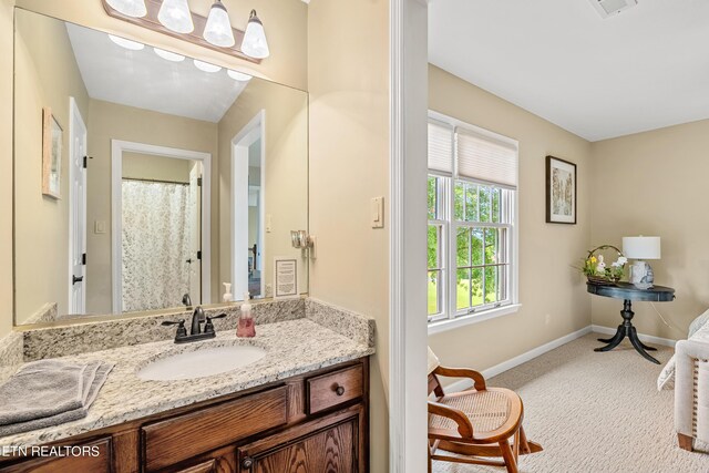 bathroom with vanity and a shower with shower curtain