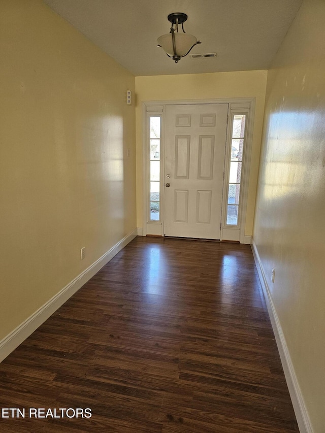 foyer entrance featuring dark hardwood / wood-style floors