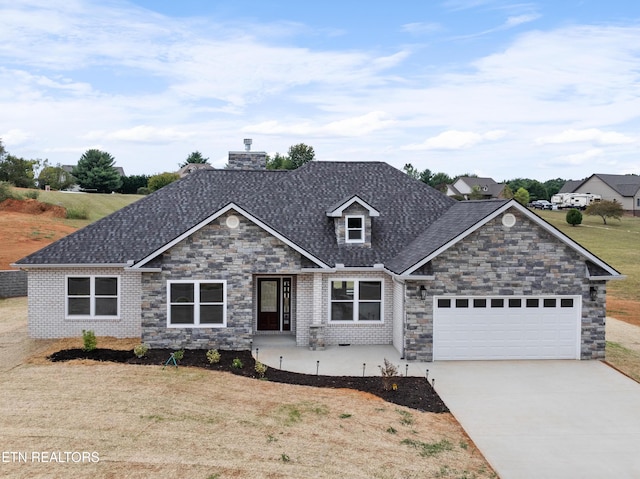 view of front of home with a garage and a front lawn