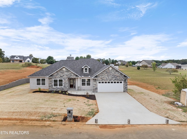 view of front of property featuring a front yard and a garage