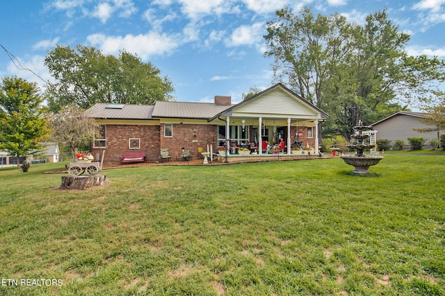 back of property with a lawn and a patio area