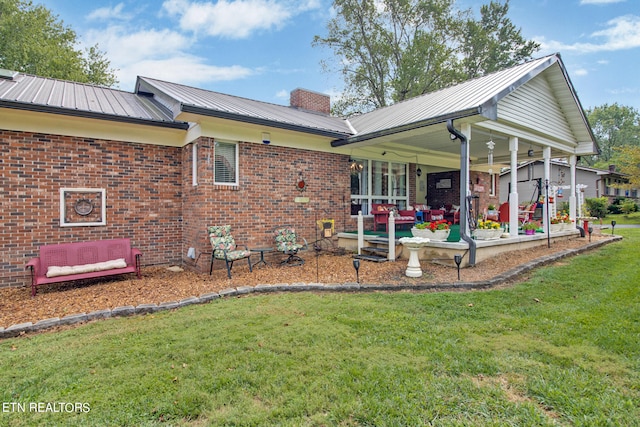 back of house with a yard, ceiling fan, and a patio area