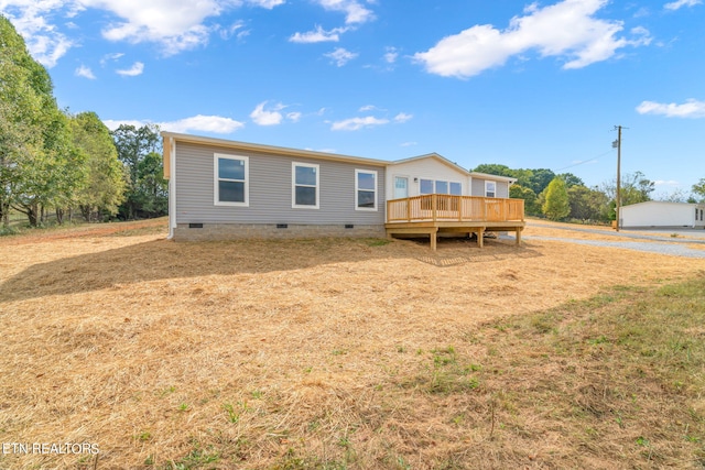 rear view of property with a wooden deck